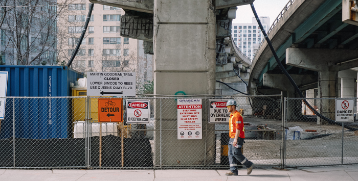 A photo of a construction worker walking on a construction site